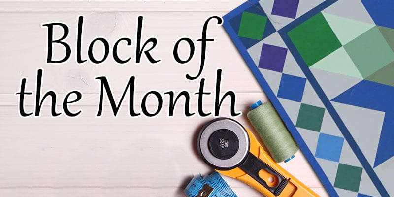 Banner image featuring the words 'Block of the Month' in elegant script, with a colorful geometric quilt pattern in the background, a rotary cutter, a measuring tape, and a spool of green thread..