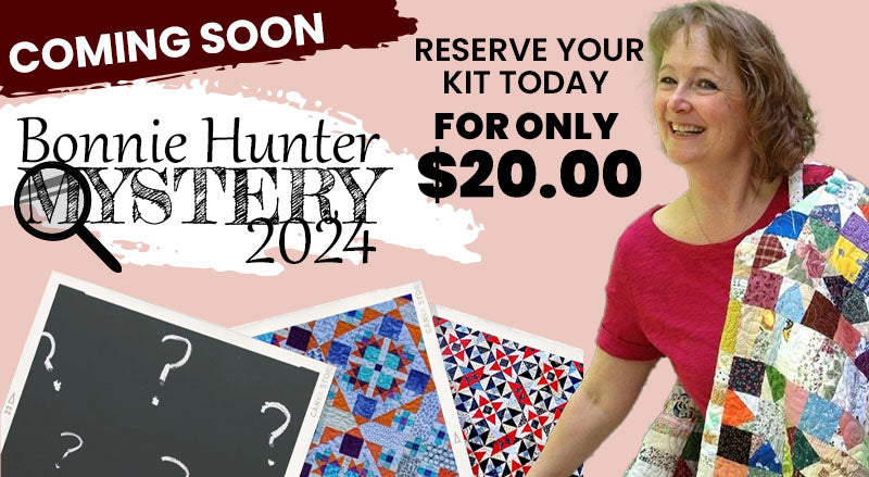 Image of Bonnie Hunter with two of her past Mystery Quilts: Bonnie Hunter Mystery Quilt Along. Reserve your kit for only $20.