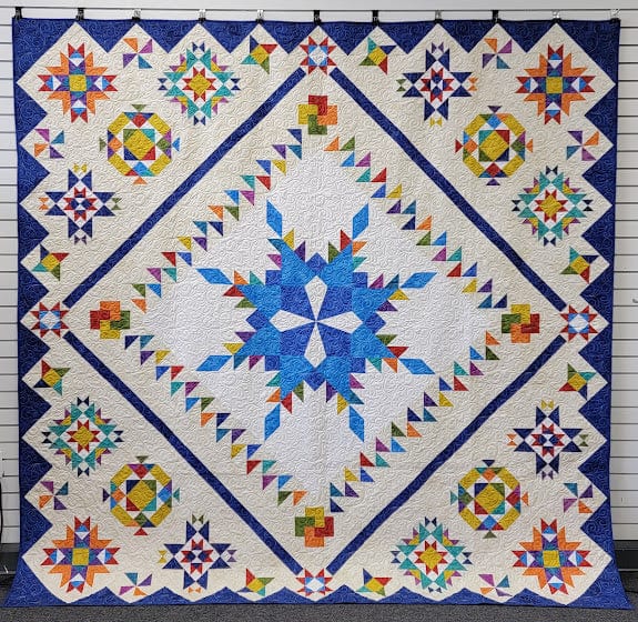 cover_finished_quilt.Snowflake_Feathered_Star_Sampler.jpg