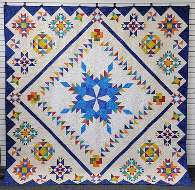 Image of Snowflake Feathered Star Sampler quilt.